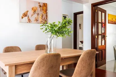 a dining room with a wooden table and chairs at City Views Apartment Funchal in Funchal