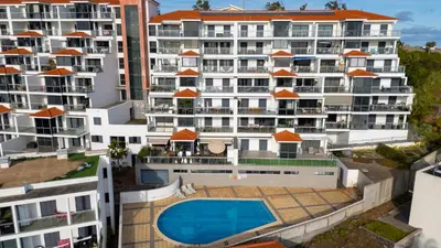 an aerial view of a building with a swimming pool at Amethyst by LovelyStay in Caniço