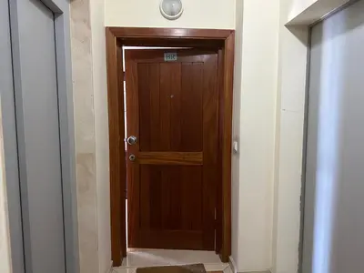 a hallway with a wooden door in a room at Forum Madeira pokoje in Funchal