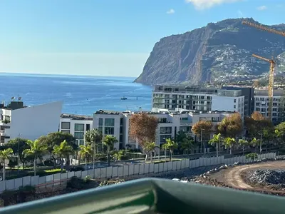 a view of a city with a mountain in the background at Forum Madeira pokoje in Funchal