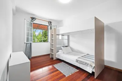 a bedroom with a bunk bed and a window at Caniço Seaview House in Caniço