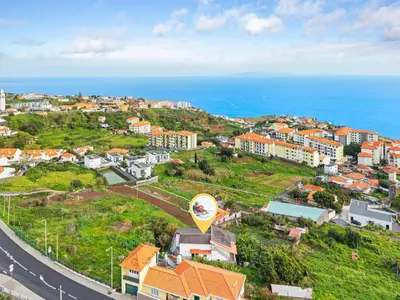an aerial view of a city with the ocean at Caniço Seaview House in Caniço