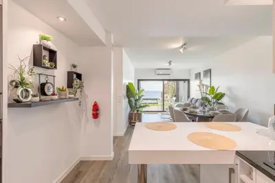 a kitchen and living room with a table and chairs at Luna do Mar - Luxury apt with Jacuzzi in Gaula
