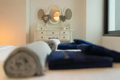 a bedroom with a bed and a dresser with mirrors at Luna do Mar - Luxury apt with Jacuzzi in Gaula