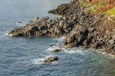 a group of rocks in the water near the ocean at Luna do Mar - Luxury apt with Jacuzzi in Gaula