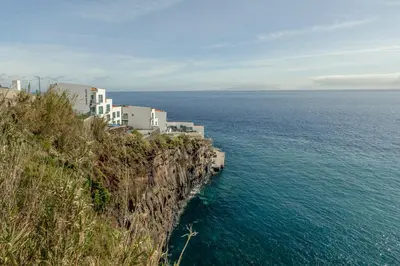 a building on a cliff next to the ocean at Luna do Mar - Luxury apt with Jacuzzi in Gaula