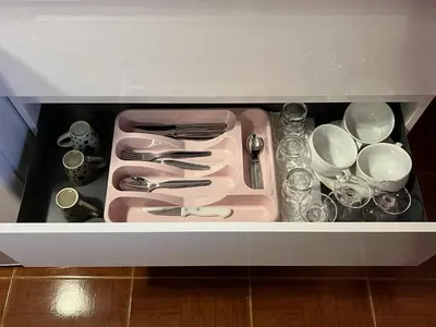 a white drawer filled with dishes and utensils at Casa Levada Explorer - Cozy Nights & Easy Meals in Santana