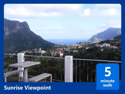 a bench sitting on a balcony with a view of the mountains at Casa Levada Explorer - Cozy Nights & Easy Meals in Santana