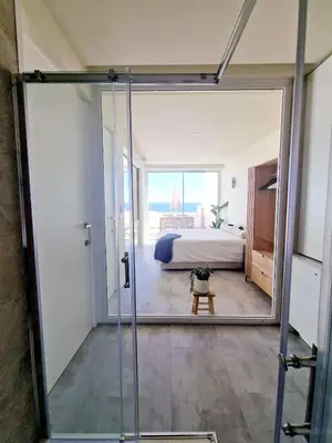a room with a glass door leading to a bedroom at Romantic Escape - Private jacuzzi and WOW seaview in Lagos