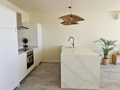 a kitchen with a white counter and a sink at Romantic Escape - Private jacuzzi and WOW seaview in Lagos