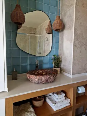 a bathroom with a sink and a mirror at Romantic Escape - Private jacuzzi and WOW seaview in Lagos