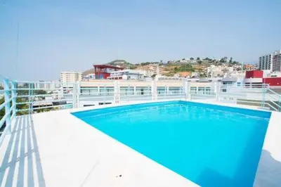 a swimming pool on the roof of a building at Madeira Sun in Funchal