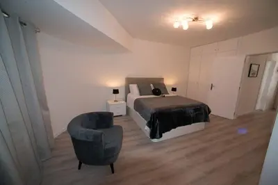 a bedroom with a bed and a chair at Madeira Sun in Funchal