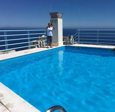 a man taking a picture of a swimming pool on a cruise ship at Madeira Sun in Funchal