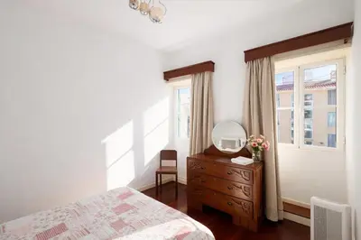 a bedroom with a bed and a mirror on a dresser at Violeta House in Funchal
