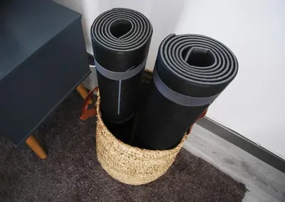 two black tubes in a basket next to a desk at Ocean View Apartment near Arrifana Beach with Parking in Aljezur