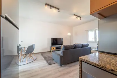 a living room with a couch and a tv at Ocean View Apartment near Arrifana Beach with Parking in Aljezur