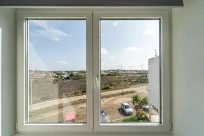 a window with a view of a car park at Ocean View Apartment near Arrifana Beach with Parking in Aljezur