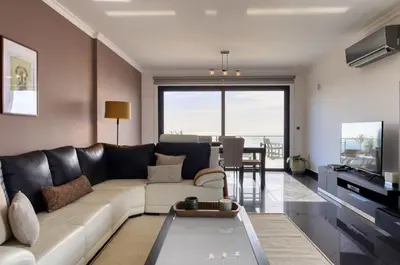 a living room with a couch and a table at Oasis do Sol, a Home in Madeira in Ponta do Sol