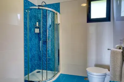 a bathroom with a shower and a toilet at Oasis do Sol, a Home in Madeira in Ponta do Sol