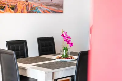 a dining room table with a vase of flowers on it at GuestReady - Alluring island retreat in Santa Cruz