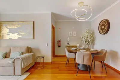 a living room with a table and a couch at Ti Clara Serenity Apartment in Caniço