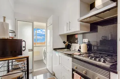 a kitchen with a stove and a microwave at Ti Clara Serenity Apartment in Caniço