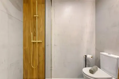 a bathroom with a toilet and a shower at Ti Clara Serenity Apartment in Caniço