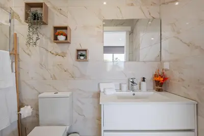 a bathroom with a sink and a toilet and a mirror at Casa Avô ladeira 2 in Estreito da Calheta