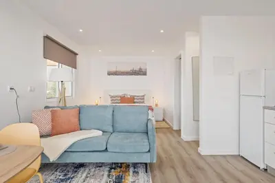 a living room with a blue couch and a table at Casa Avô ladeira 2 in Estreito da Calheta