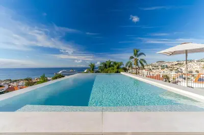 a swimming pool with a view of the ocean at Casa Modelo in Funchal