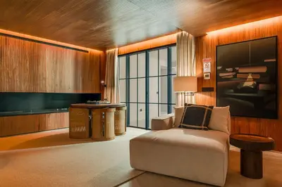 a living room with a chair and a large window at Casa Modelo in Funchal