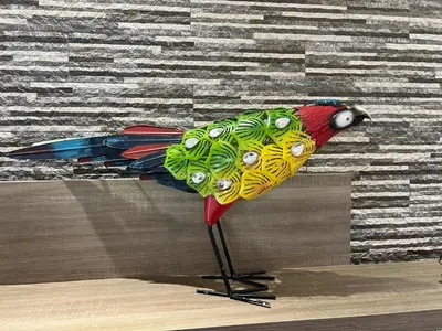 a colorful bird on a stand in front of a wall at Villa Vieira Ocean View in Gaula