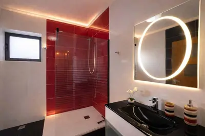 a bathroom with a black sink and a mirror at Villa Vieira Ocean View in Gaula