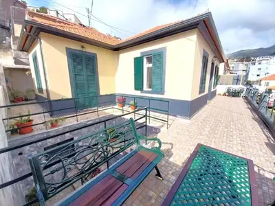 a patio with two benches and a table on a balcony at Recanto da Maria, by Specialstays in Funchal