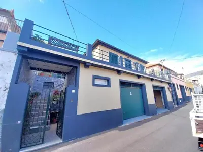 a house with green doors and a brick patio at Recanto da Maria, by Specialstays in Funchal