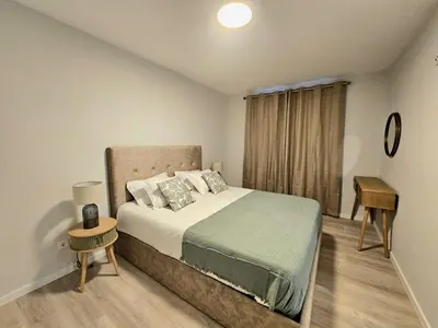 a bedroom with a large bed and a window at Garajau Palace Sea View I in Caniço