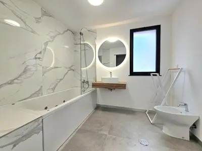 a bathroom with a sink toilet and a mirror at Garajau Palace Sea View I in Caniço