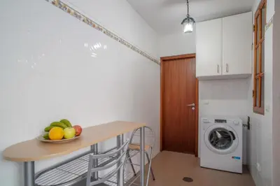 a white bathroom with a toilet and a shower at Villa Teresinha in Relógio do Poiso
