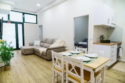 a kitchen and living room with a table and chairs at Machim by SALIM in Machico