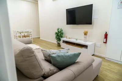 a living room with a couch and a flat screen tv at Machim by SALIM in Machico