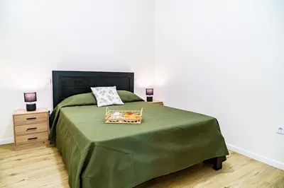 a bedroom with a green bed with a green blanket at Machim by SALIM in Machico