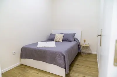 a bedroom with a bed with a purple bedspread at Machim by SALIM in Machico