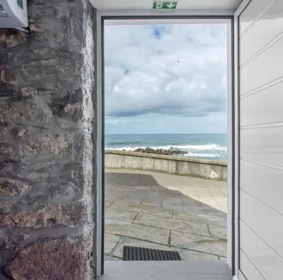 an open door with a view of the ocean at Casa Dos Avós - Sea View Studio in São Vicente
