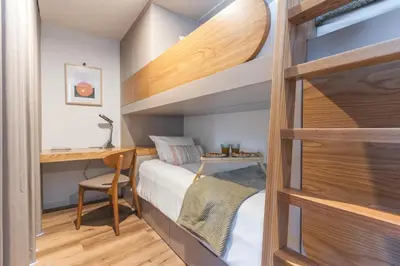 a small bedroom with a bunk bed and a desk at Big Cliff - Ocean View by AH in Câmara de Lobos