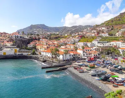 an aerial view of a beach with boats in the water at Big Cliff - Ocean View by AH in Câmara de Lobos