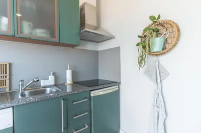 a kitchen with green cabinets and a sink at Pitanga Apartment by AH in Câmara de Lobos