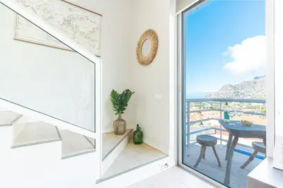a room with a window and a table with a view at Pitanga Apartment by AH in Câmara de Lobos