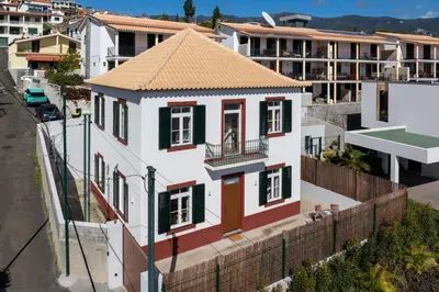 a small white house with a brown roof at Traditional House Cozy 3-bedroom house in Funchal