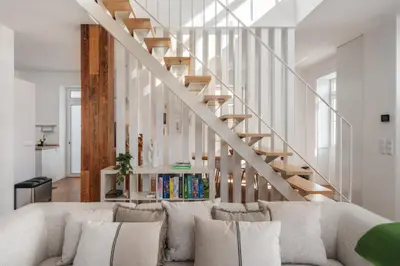 a living room with a couch and a staircase at Traditional House Cozy 3-bedroom house in Funchal